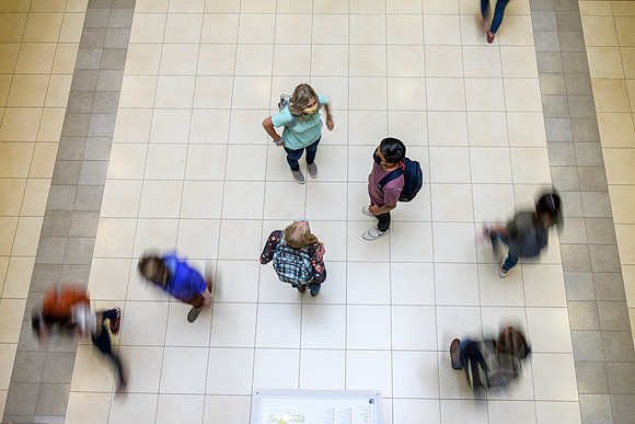 Student volunteers show the way to stay safe during this COVID 19 pandemic by social distancing, following pathway arrows and proper wearing of masks .