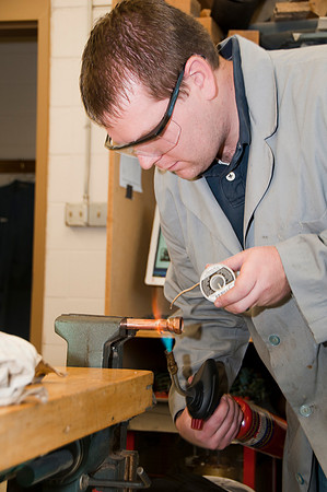 Student Ivan Stahle "sweating" a pipe in a plumbing project in Del Mortensen's Mechanical Systems class.