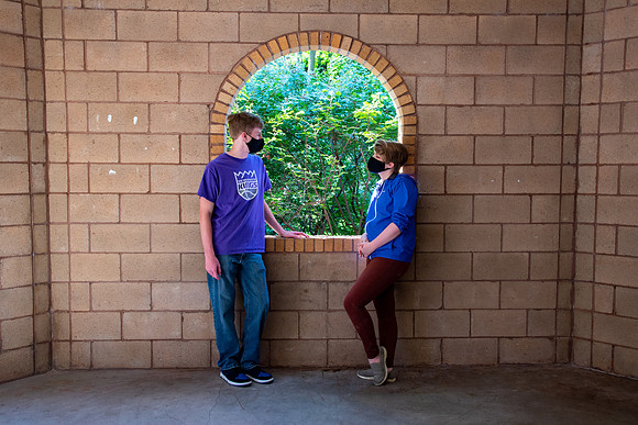 Examples of students staying safe and healthy during the COVID-19 pandemic by social distancing, following pathway arrows, and wearing face masks.