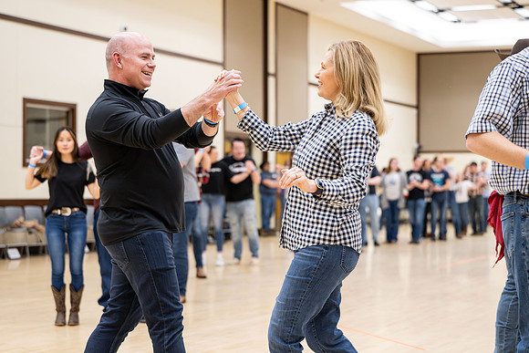 President and Sister Meredith try country dancing.