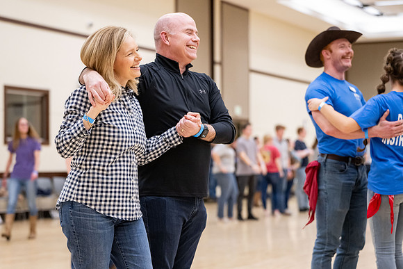 President and Sister Meredith try country dancing.
