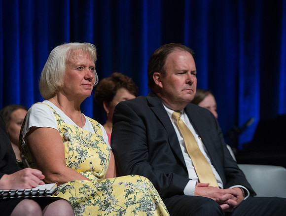 Roger Jackson sits with his wife during devotional.