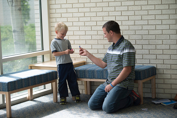 Father watches son while waiting for wife.