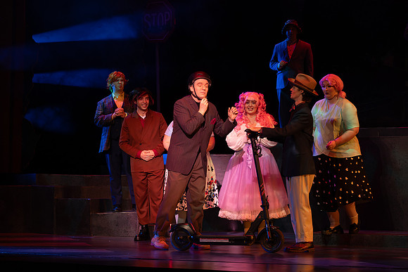 Students performing in the play The Mikado.