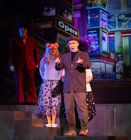 Students performing in the play The Mikado.