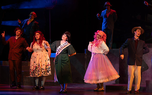 Students performing in the play The Mikado.