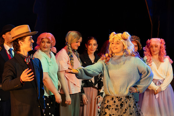 Students performing in the play The Mikado.