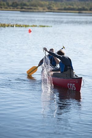 Students in the class of Principle of Fish Management,taught by Brother Billman, learn how to set gill nets to capture fish in the ponds at Sand Creek.