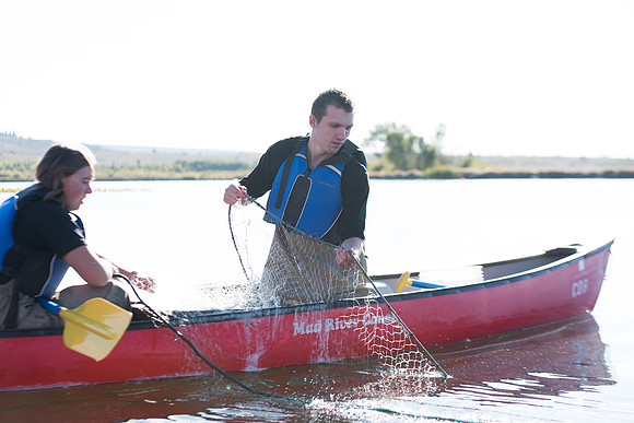 Students in the class of Principle of Fish Management,taught by Brother Billman, learn how to set gill nets to capture fish in the ponds at Sand Creek.