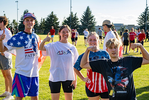Students gather at the upper field for various 4th of July activities.