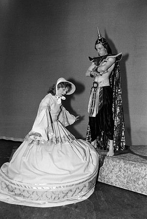 Lady bowing down to the King.