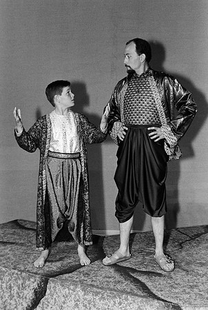 A man and a kid staring at each other.
