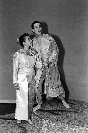 A man talking to a lady while looking up.