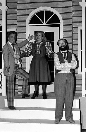Actors standing on the porch.