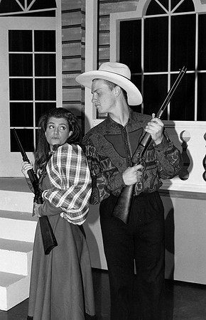 A man and a woman holding rifles