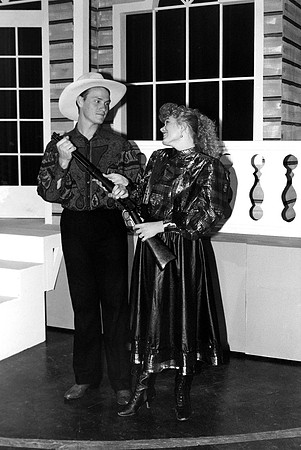 A man and a woman holding rifles