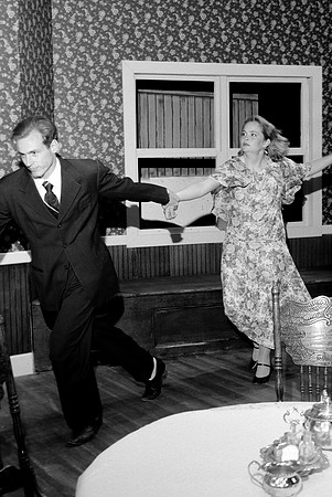 A man grabing a woman by the wrist and running.