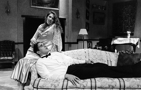 Actress playing with mans hair while he lies his head down on her lap.