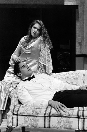 Actress playing with mans hair while he lies his head down on her lap.