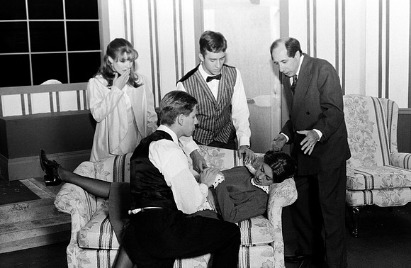"Ten Little Indians" by Agatha Christie. The maid is laying on the coach with people around her.