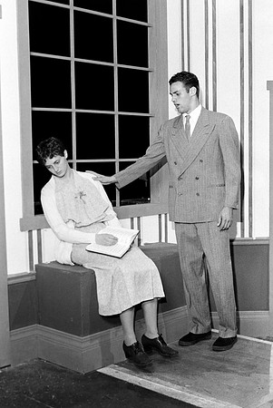 The male actor is trying to comfort the female actress.