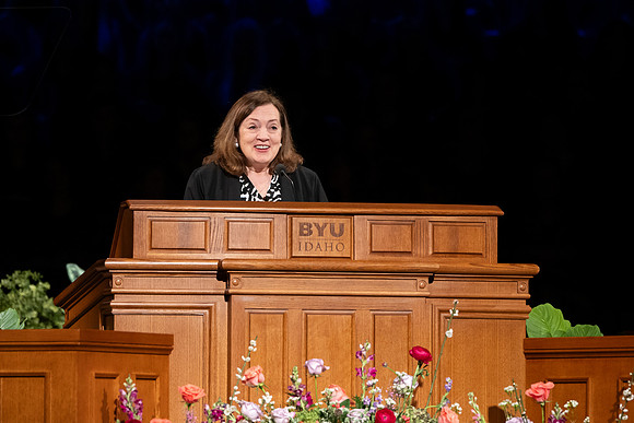 Elder and Sister Gong address BYU-Idaho students during devotional.