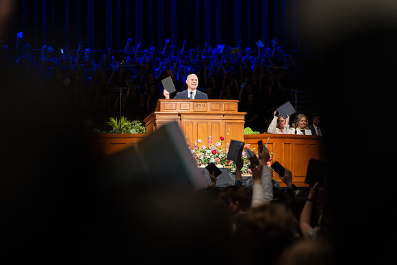 Elder and Sister Gong address BYU-Idaho students during devotional.