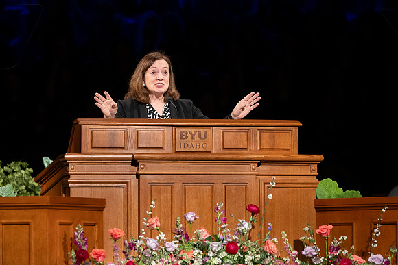 Elder and Sister Gong address BYU-Idaho students during devotional.