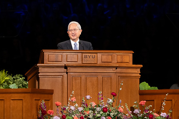Elder and Sister Gong address BYU-Idaho students during devotional.