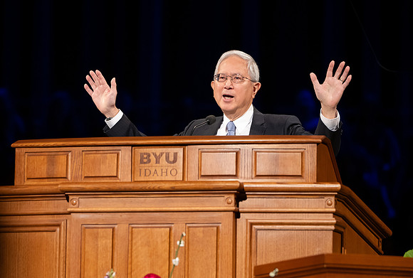 Elder and Sister Gong address BYU-Idaho students during devotional.