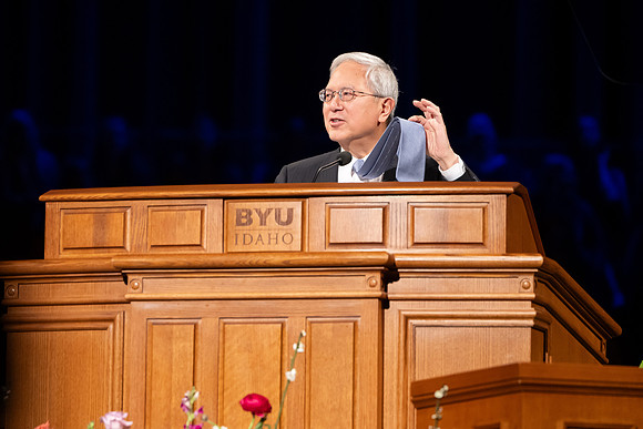 Elder and Sister Gong address BYU-Idaho students during devotional.