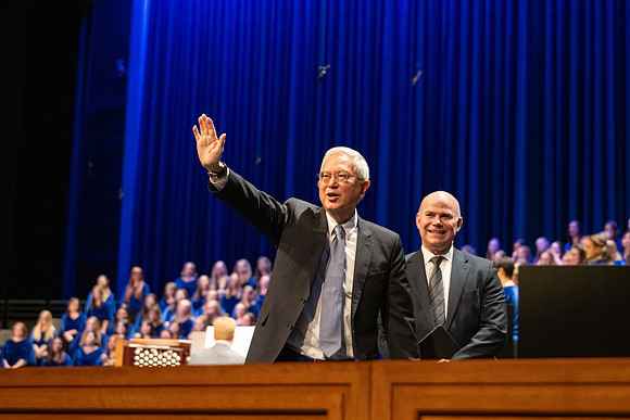 Elder and Sister Gong address BYU-Idaho students during devotional.
