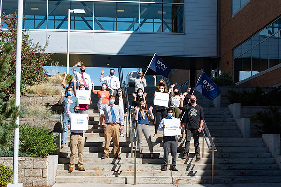 Drone shots of faculty groups around campus say "We're in this together."