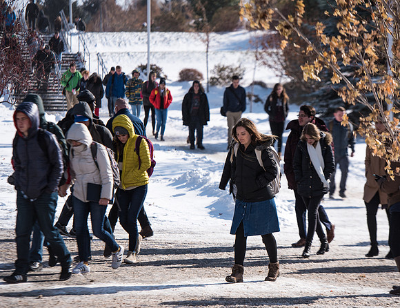 Students walking into devotional in the snow, Fall Semester.