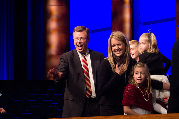 Clark G. Gilbert and his family recognize a familiar face in the crowd. Taken by Erik Hill.