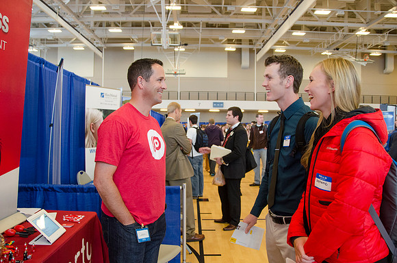 BYU-Idaho students speak to representatives from colleges or companies from their field of study at a career fair held in the I-Center gym