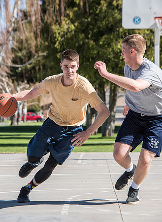 Jacob and Jacob, two BYU-Idaho students, play one on one basketball at the Smith Park court.