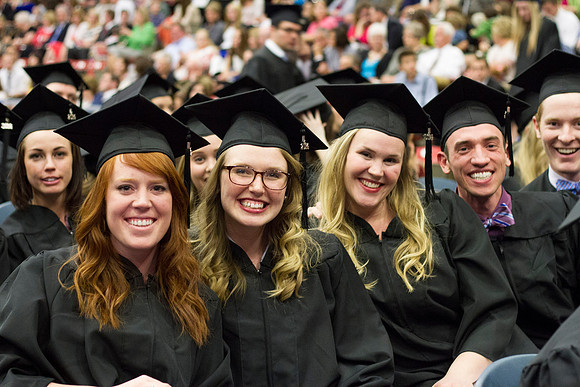 Graduates eagerly smile before Convocation begins in the Hart Auditorium during the 2014 Winter Semester Graduation at BYU-Idaho. Photo by Tyler Rickenbach