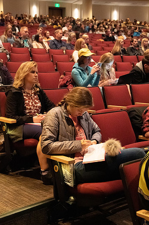 Students taking notes as they listen to devotional in the BYU-Idaho Center. Devotional - Nov 2019