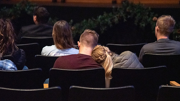 Students taking notes as they listen to devotional in the BYU-Idaho Center. Devotional - Nov 2019