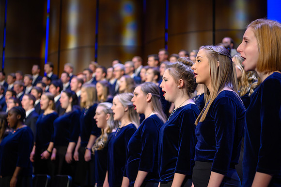 The men's and women's combined choir perform during devotional held in the BYU-Idaho Center, Fall Semester.