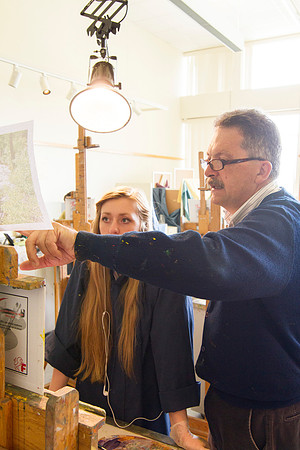 Brother Vince Bodily points out to one of his students, the things that need to be included in her painting.