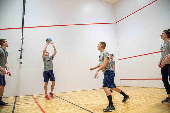 Group of students playing wallyball at BYU-Idaho raqetball courts in the Hart Auditorium building.