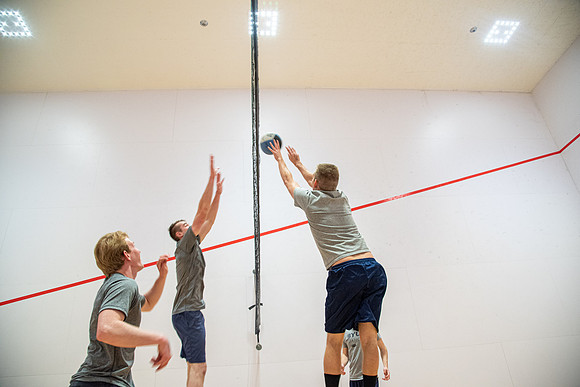 Group of students playing wallyball at BYU-Idaho raqetball courts in the Hart Auditorium building.