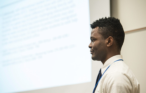 Faculty gather in the Hinckley Building for a conference to learn from their peers. IInternational student Paul Adah