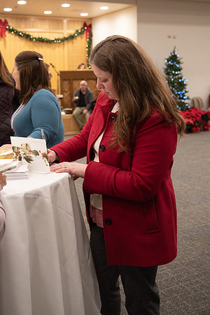 Employee writing a card at the Employee Christmas Pie Social.