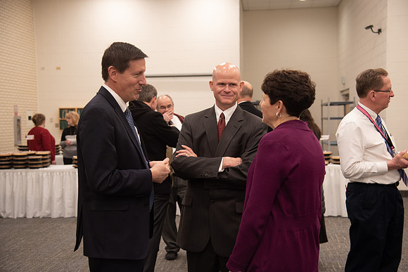 Employees socializing at the Employee Christmas Pie Social.