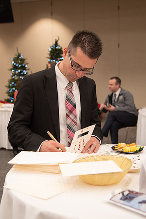 Employee writing a card at the Employee Christmas Pie Social.