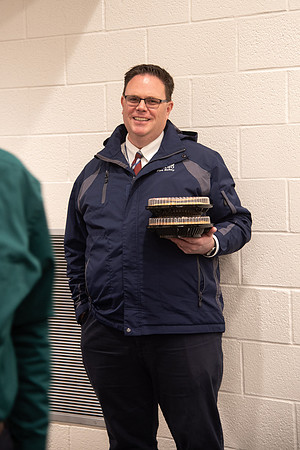 Employee holding his pies at the Employee Christmas Pie Social.