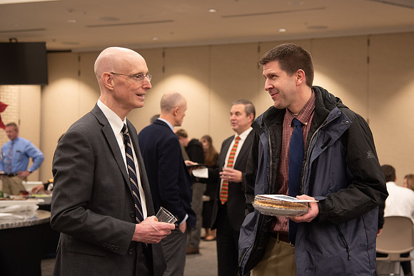 President Eyring socializing with an employee at the Employee Christmas Pie Social.